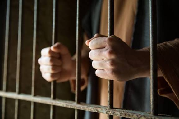 Prison ministry team preaching and leading inmates to Christ